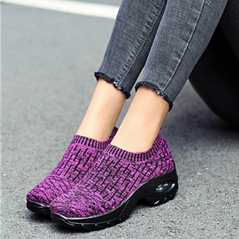 a close up of a person's feet wearing purple shoes