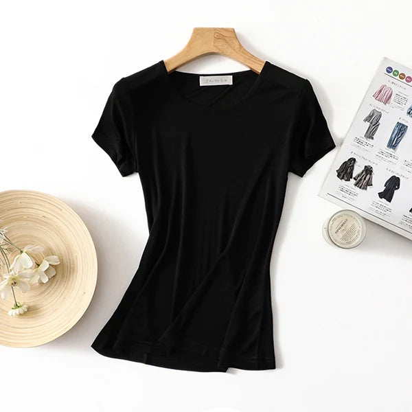 a women's t - shirt and a hat on a table