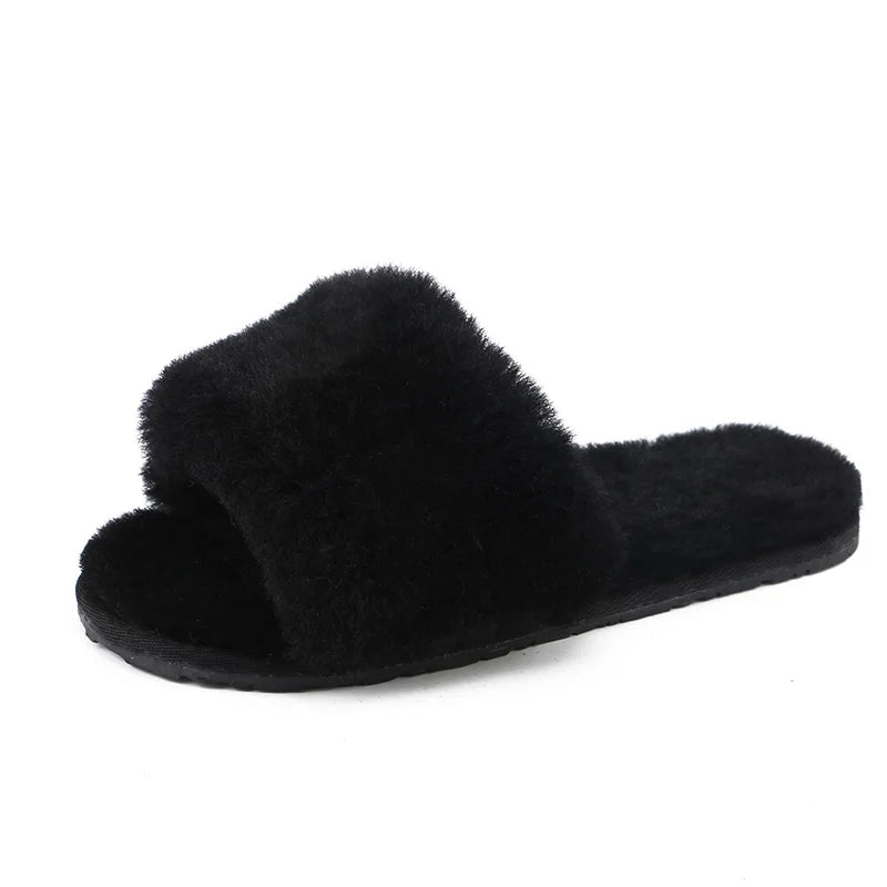 a pair of black slippers on a white background