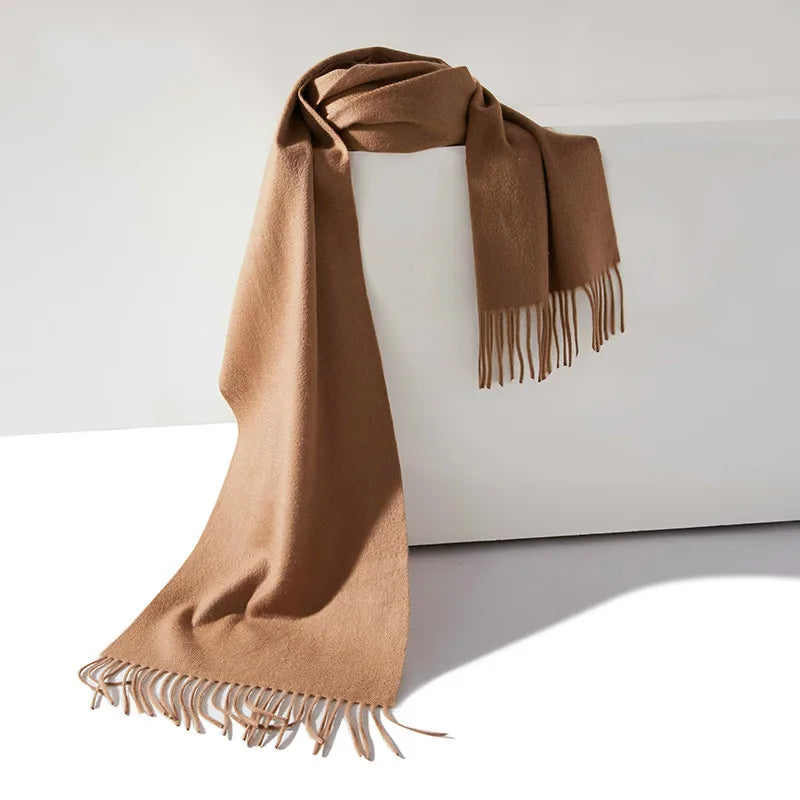 a brown scarf hanging on a white wall