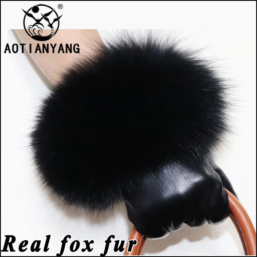 a black fur ball on top of a wooden handle