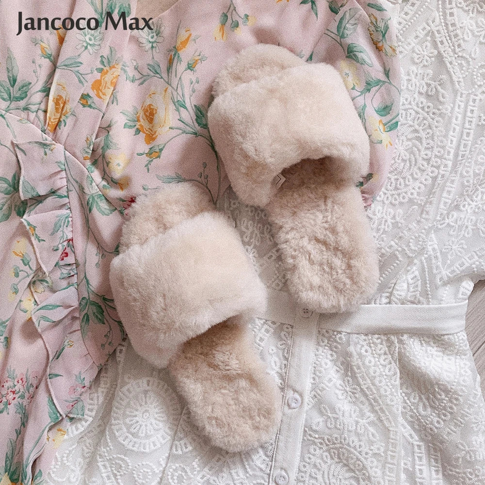 a pair of slippers laying on top of a bed