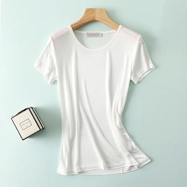 a white t - shirt sitting on top of a wooden hanger