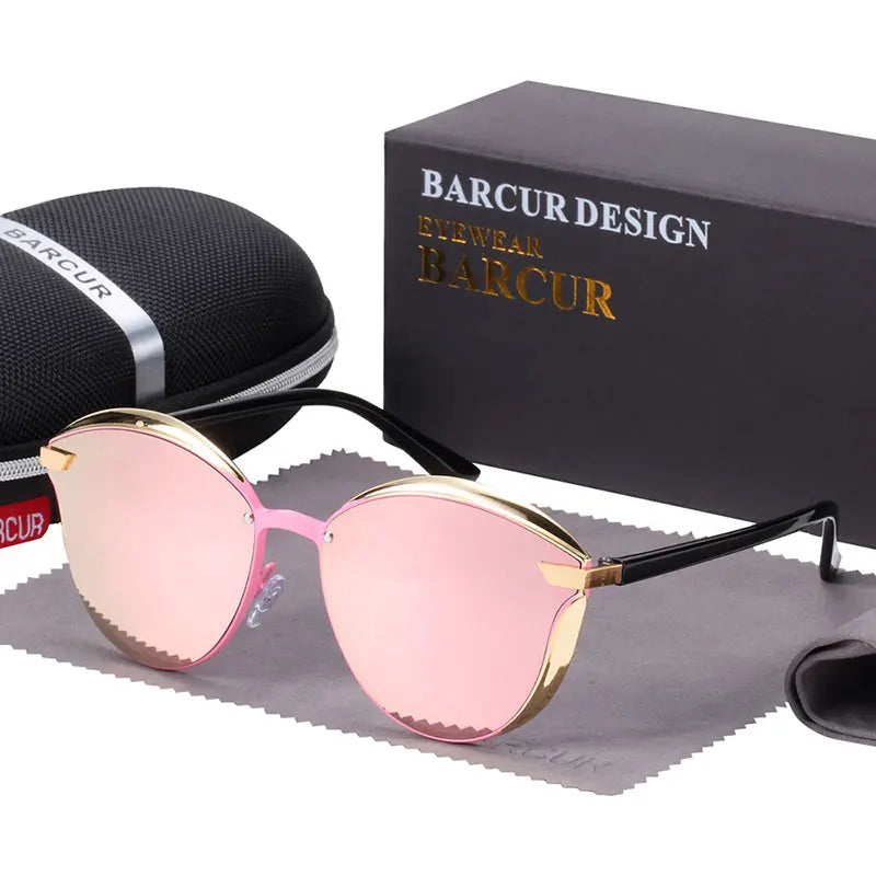 a pair of pink sunglasses next to a black case