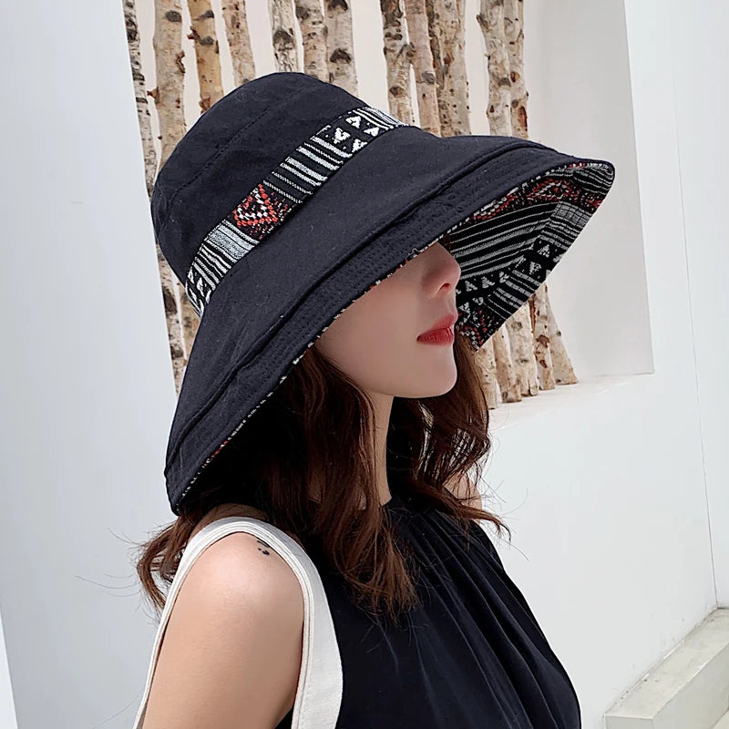 a woman wearing a black hat with a pattern on it