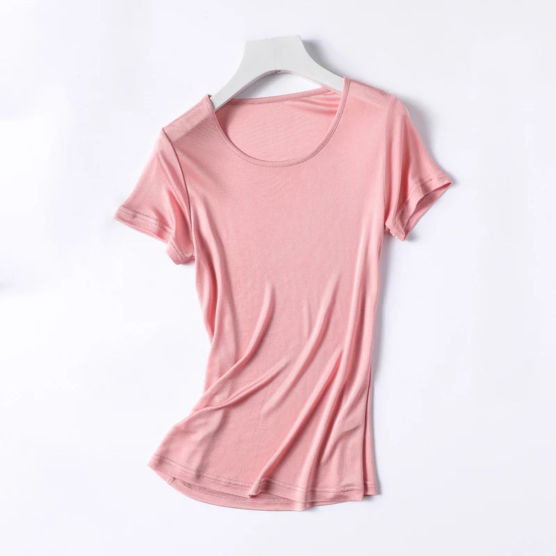 a pink t - shirt hanging on a white hanger