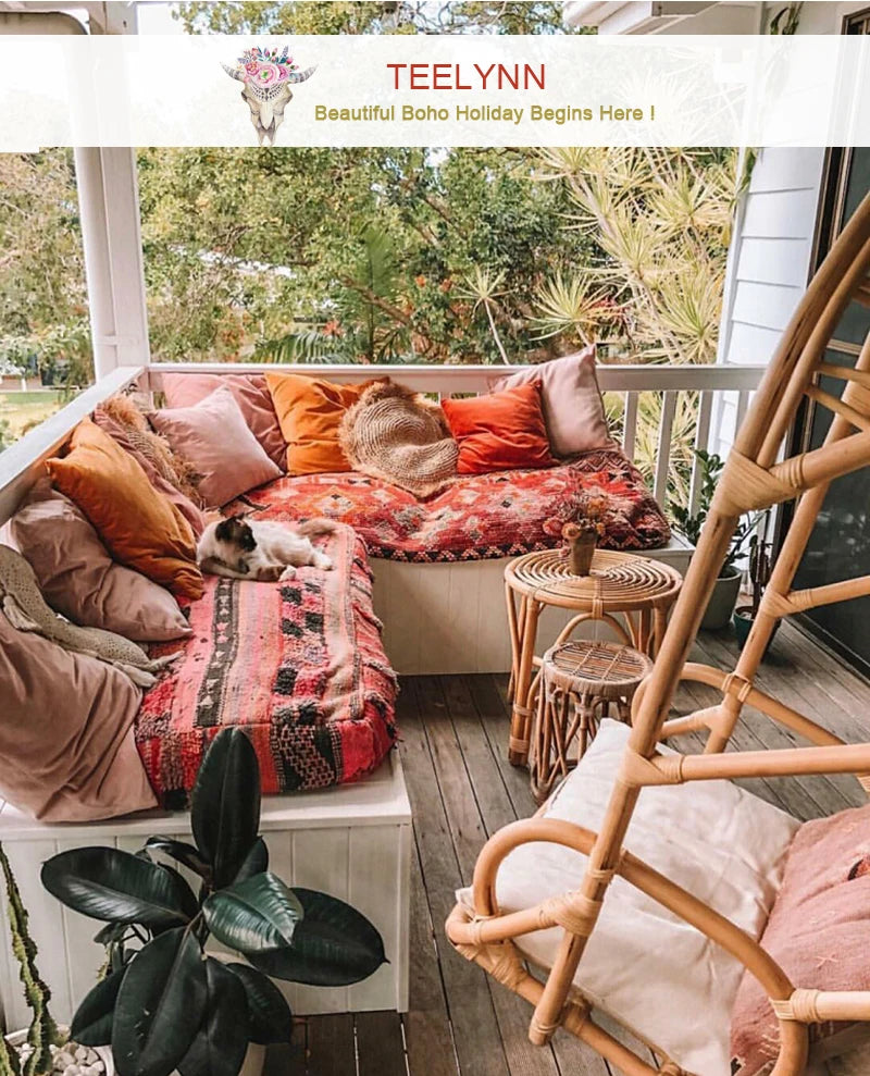 a porch filled with lots of pillows and furniture