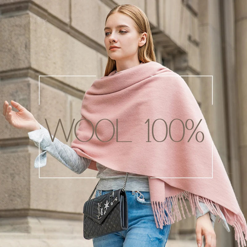 a woman walking down a street with a pink shawl