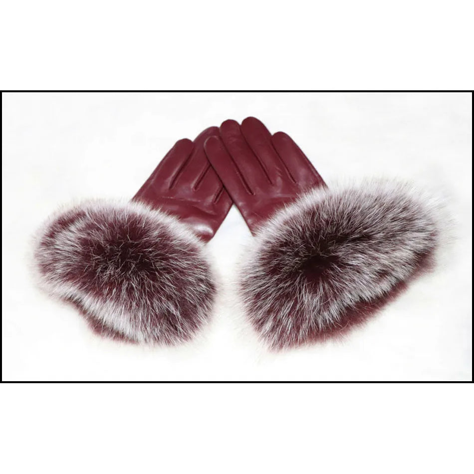 a pair of gloves with fur on top of it