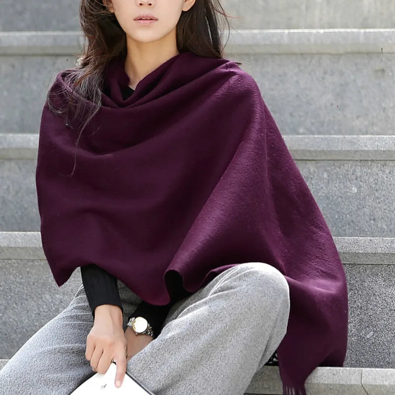 a woman sitting on steps wearing a purple shawl