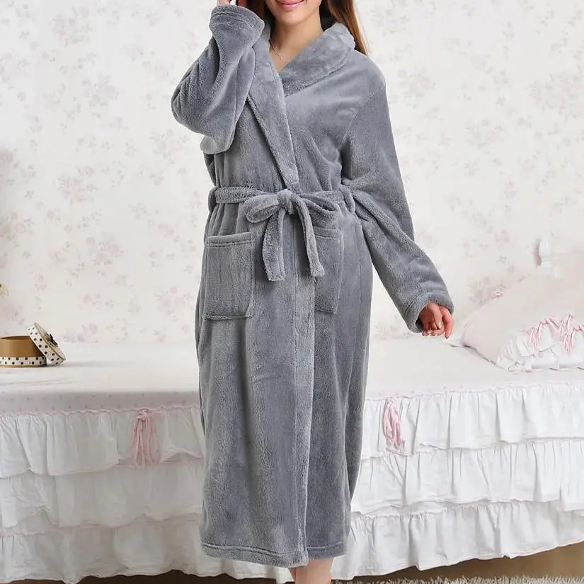 a woman in a robe standing on a bed