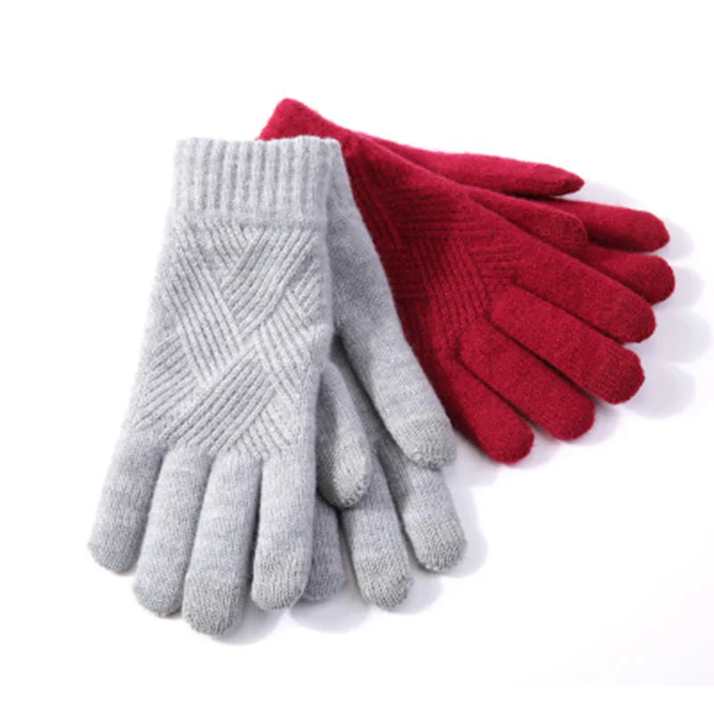 a pair of red and grey gloves sitting on top of each other