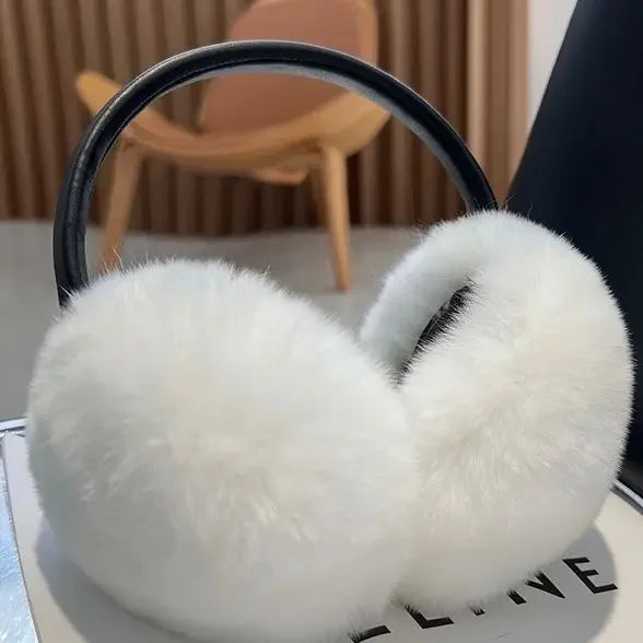 a pair of white ear muffs sitting on top of a table