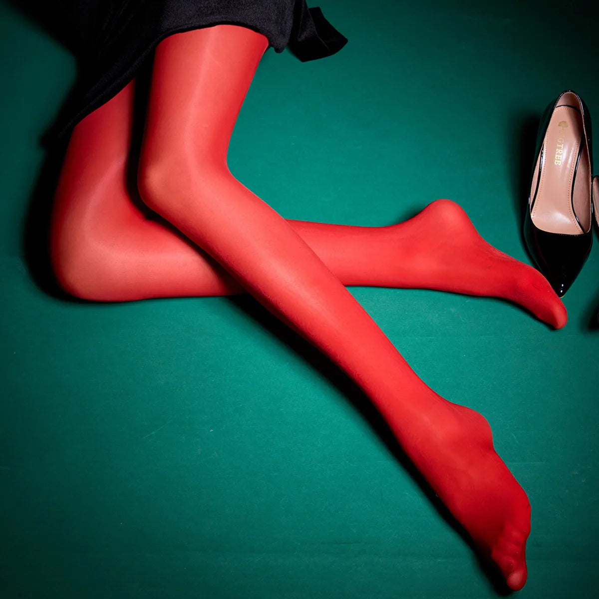 a woman's legs with red stockings and high heels