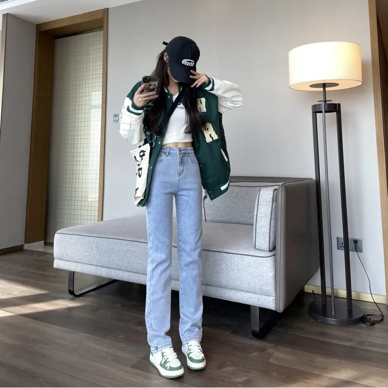 a woman standing in a living room next to a couch