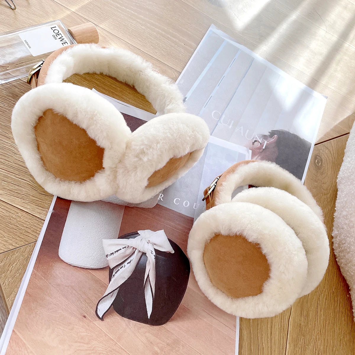 a pair of furry slippers sitting on top of a wooden floor