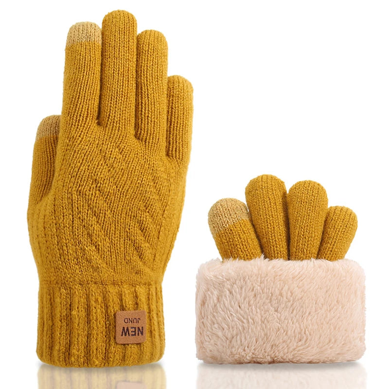 a pair of yellow mittens sitting next to each other