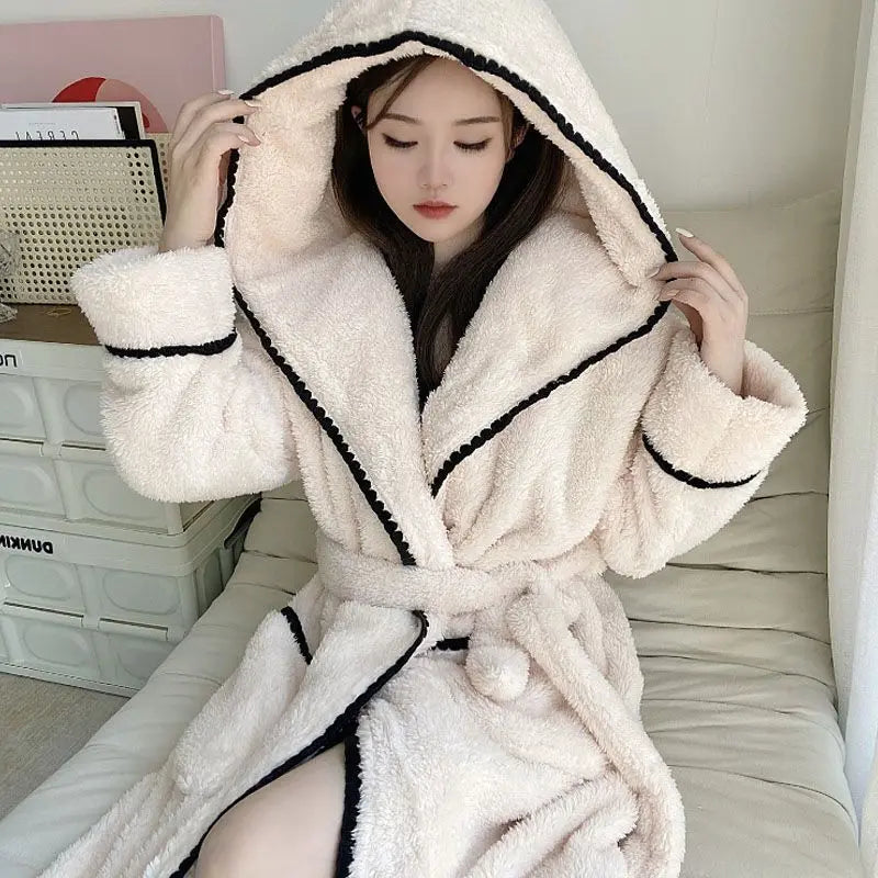 a woman in a bathrobe sitting on a bed