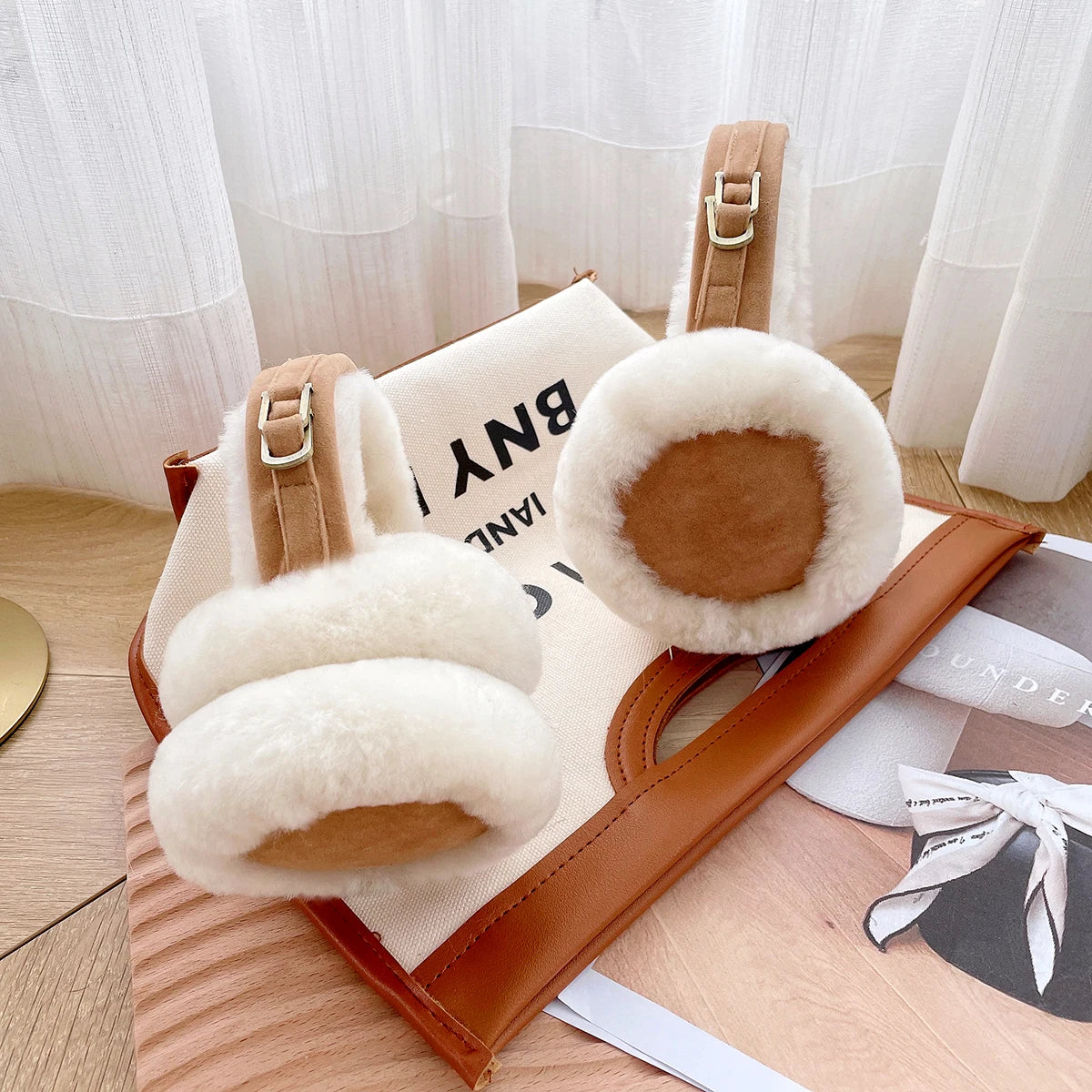 a pair of furry slippers sitting on top of a wooden tray