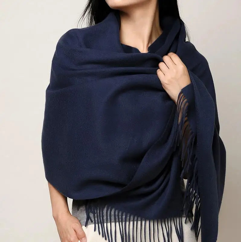 a woman wearing a blue shawl with fringes