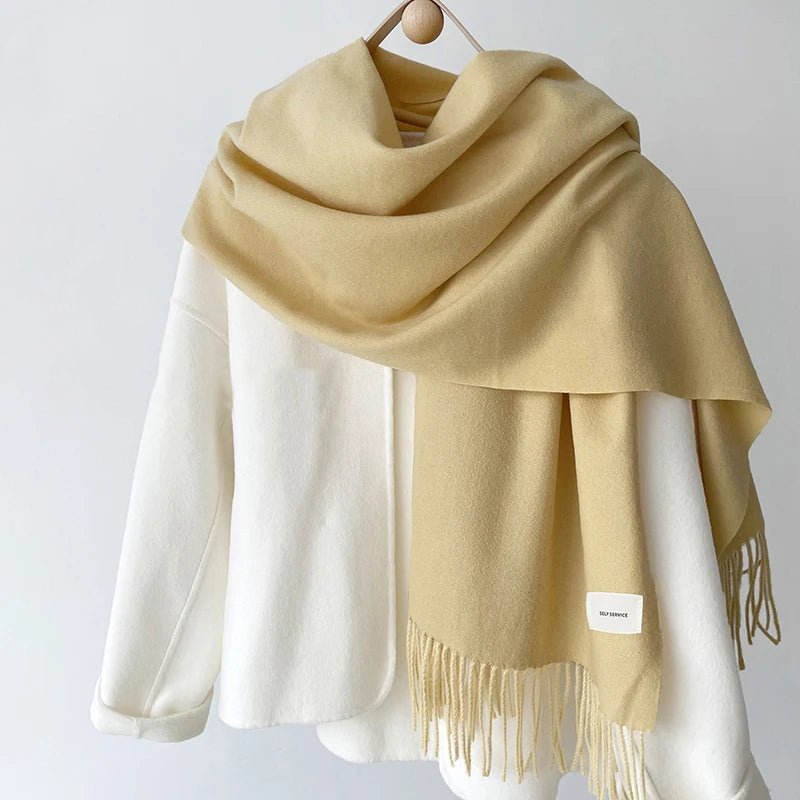 a white and yellow scarf hanging on a rack