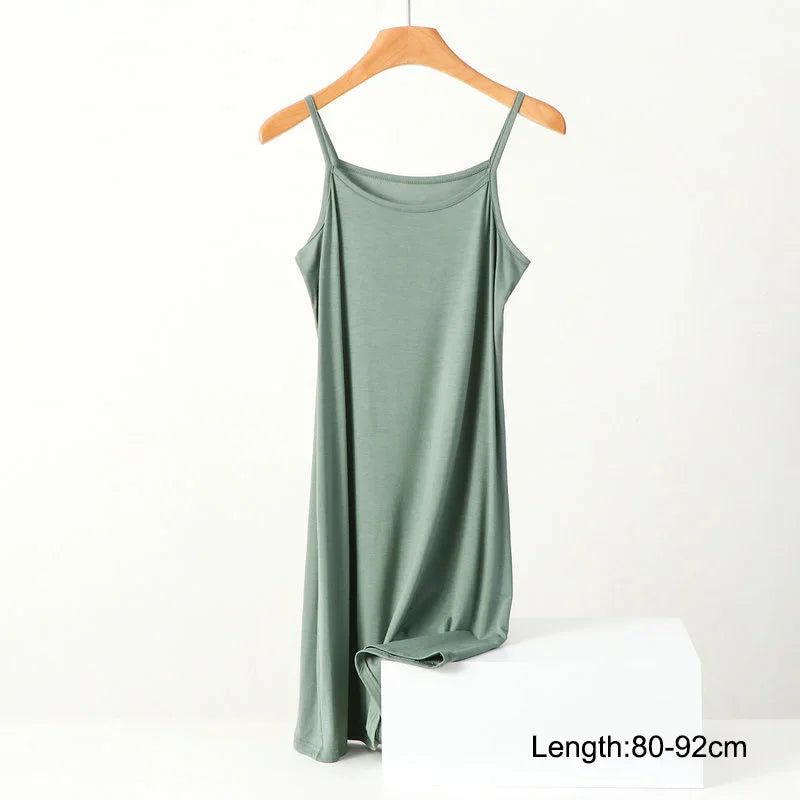 a green tank top hanging on a hanger