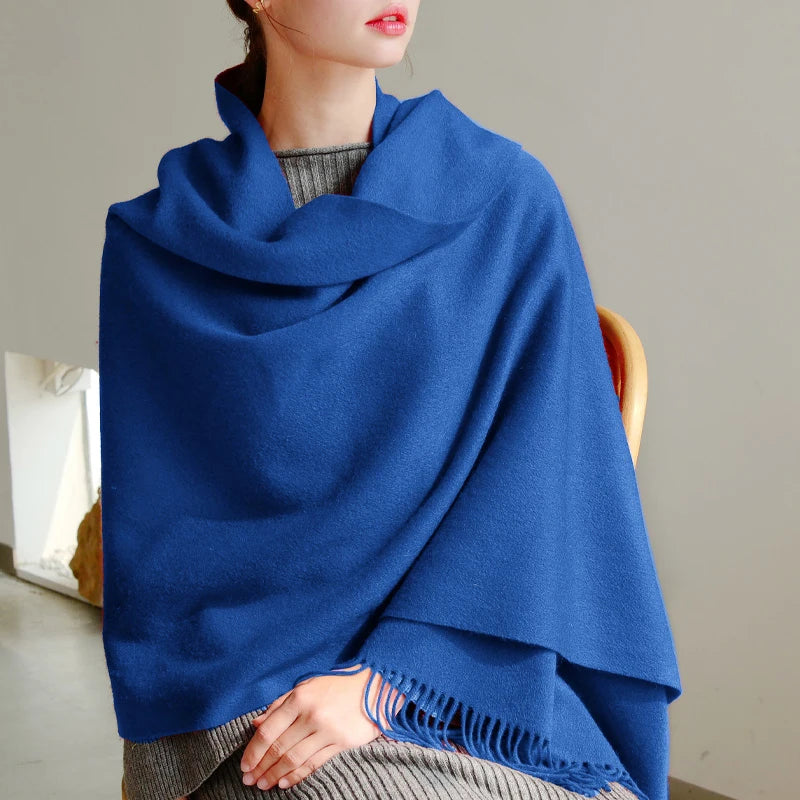 a woman wearing a blue shawl sitting on a chair