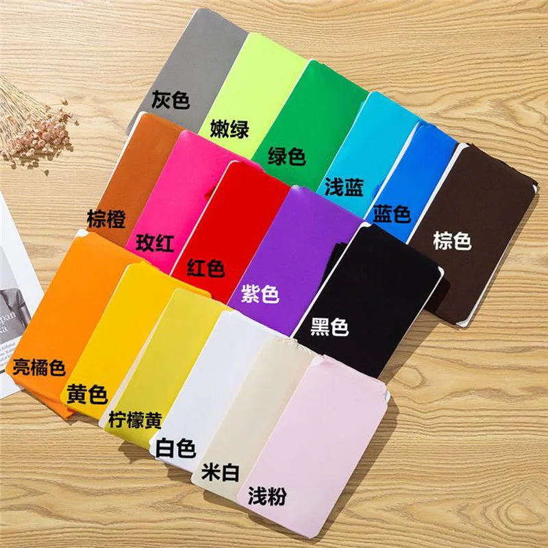 a group of different colors of notebooks on a table
