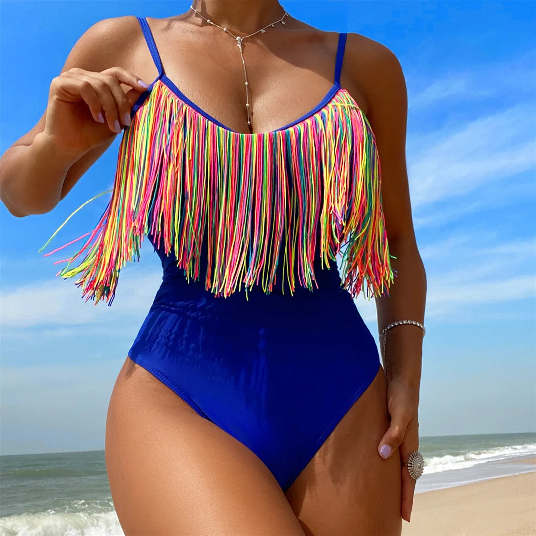 a woman in a blue swimsuit on the beach