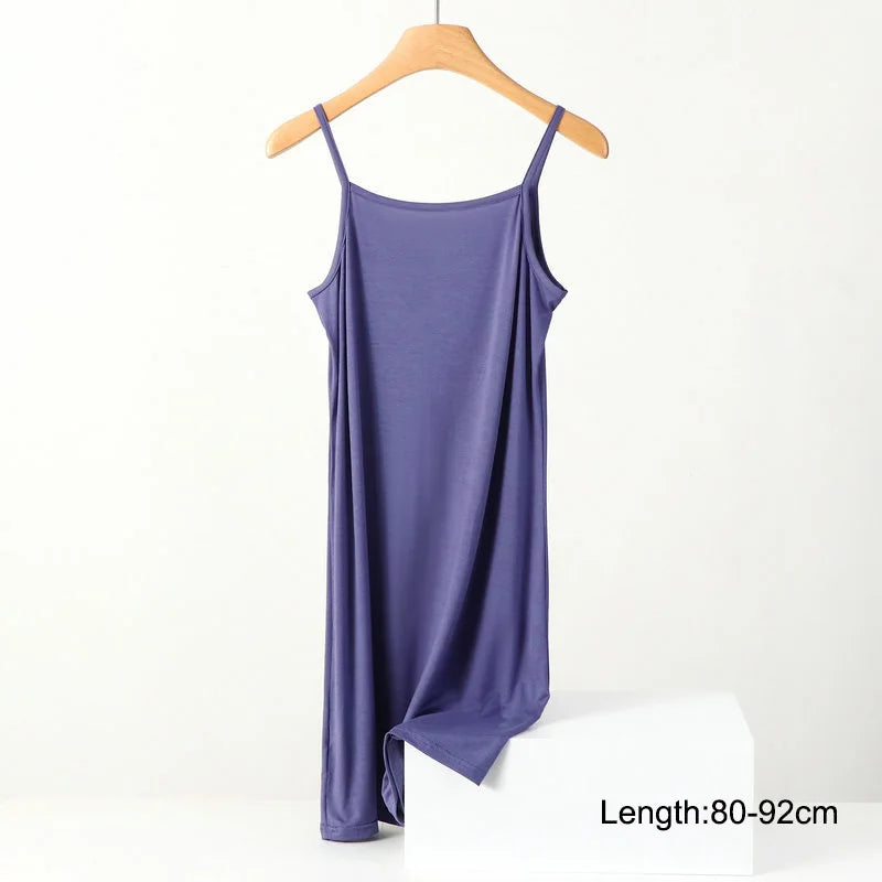 a purple tank top hanging on a wooden hanger