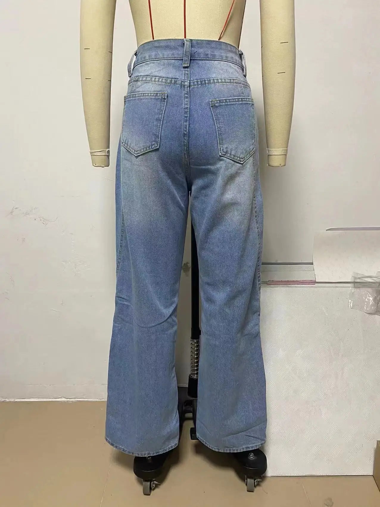 a mannequin wearing a pair of blue jeans