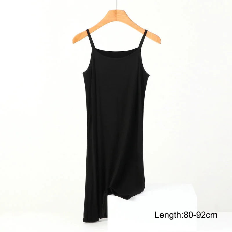 a black tank top hanging on a wooden hanger