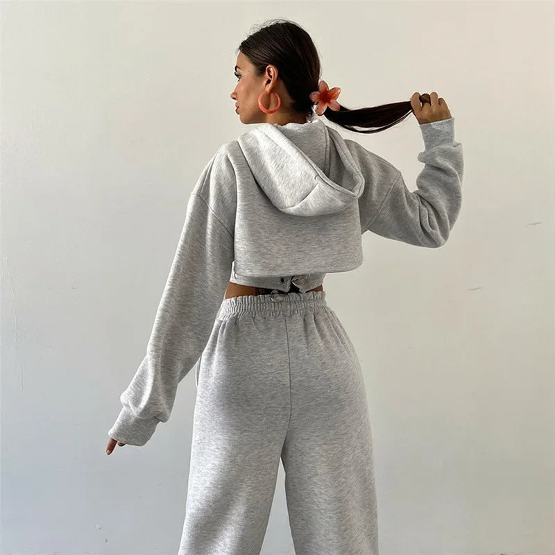 a woman in a grey sweatshirt and sweat pants