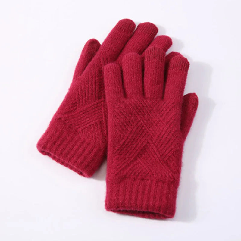 a pair of red gloves sitting on top of a white table