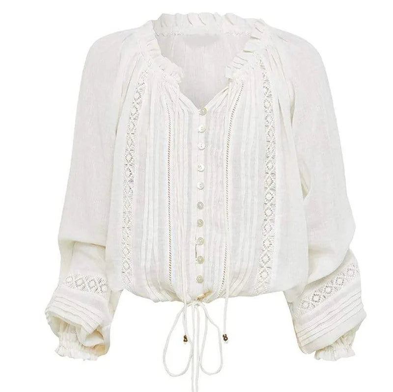 a white blouse with ruffled sleeves and a tie
