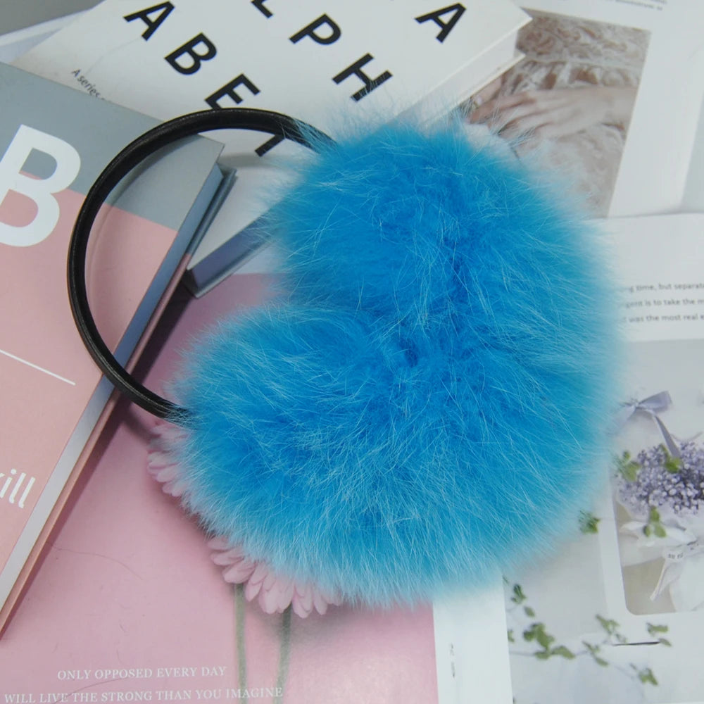 a blue furry ball on a black headband