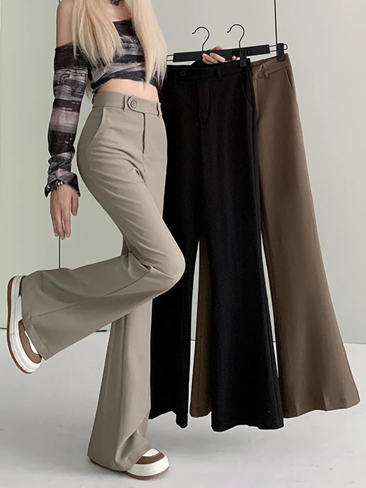 a woman standing next to a pair of pants