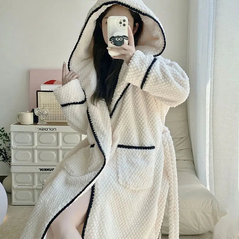 a woman taking a picture of herself in a bathrobe
