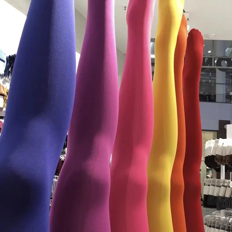 a row of different colored leggings in a store