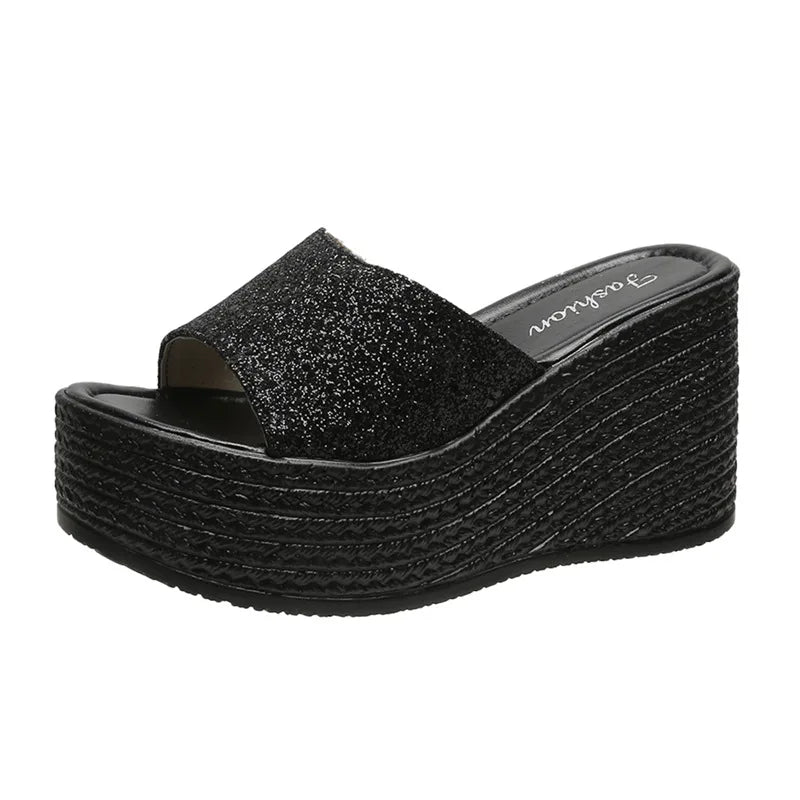 a women's black platformed sandal with an open toe