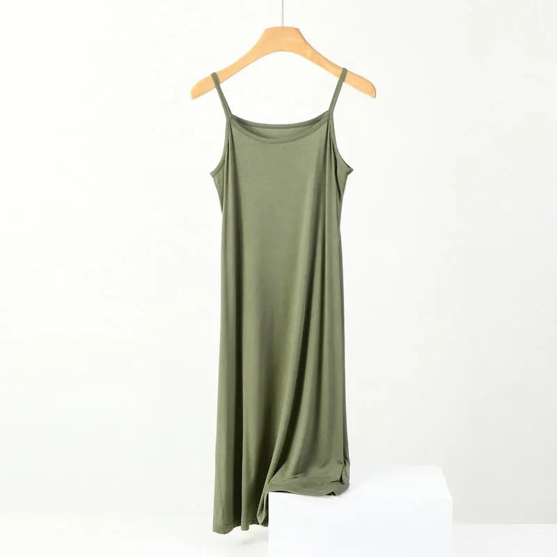 a green dress hanging on a wooden hanger