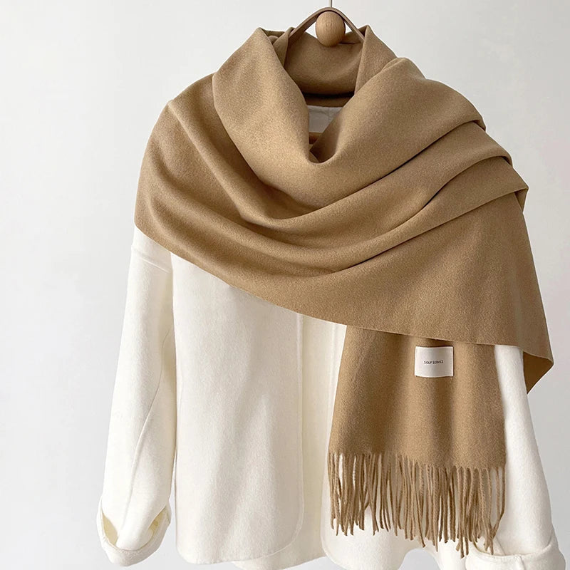 a brown and white scarf hanging on a coat rack