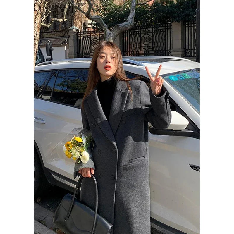 a woman standing in front of a car holding a bouquet of flowers