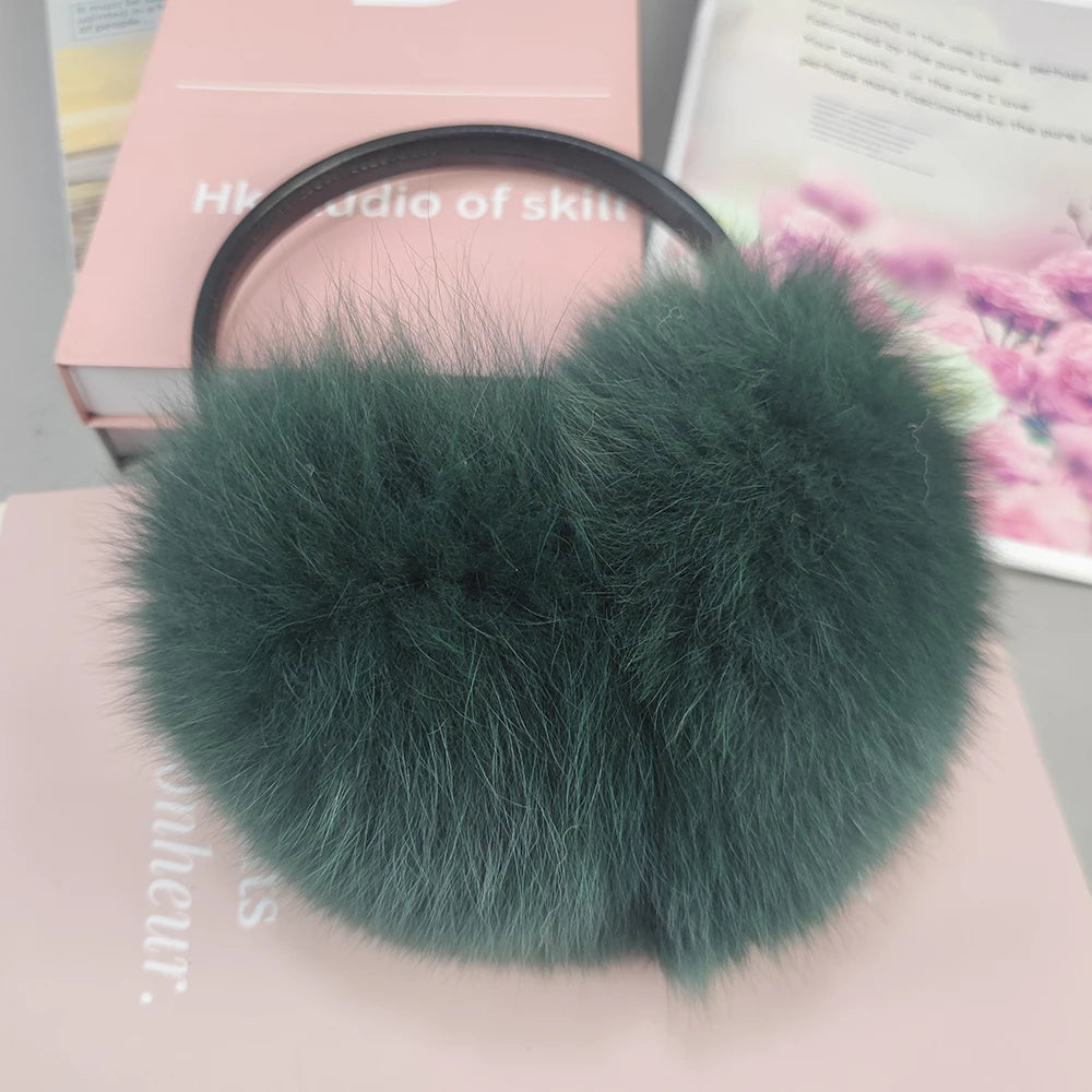 a green fur ball on top of a pink box