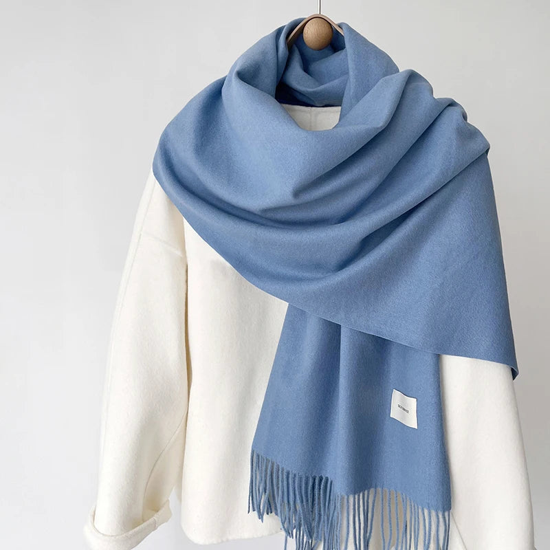 a blue and white scarf hanging on a coat rack