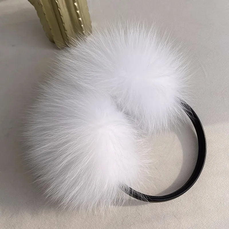 a white fur ball on a black headband