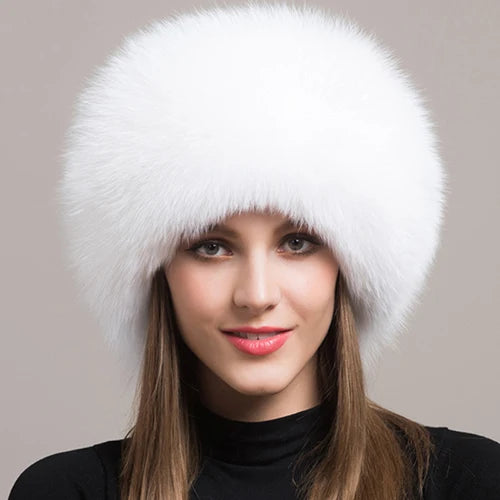 Model sporting a fluffy white natural fox fur hat, embodying elegance and warmth.