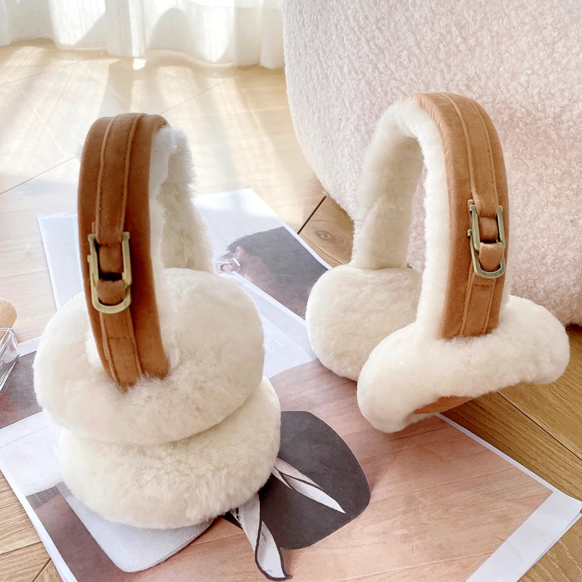 a pair of furry ear muffs sitting on top of a table