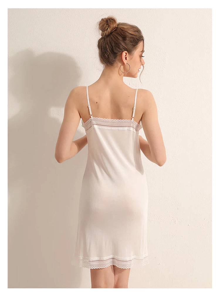 a woman in a white nightgown is looking back