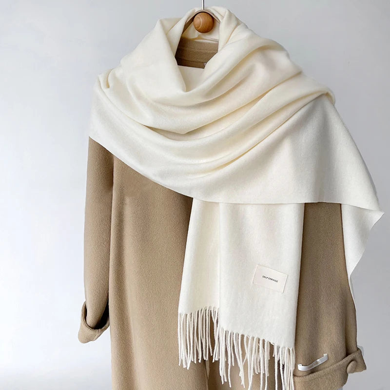 a white scarf hanging on a coat rack